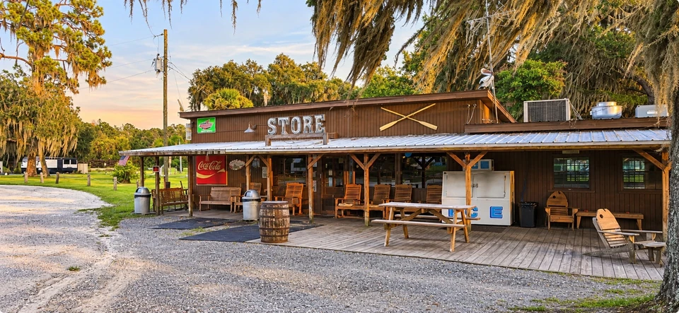 The wood-front Harbor Store with porch seating and picnic tables