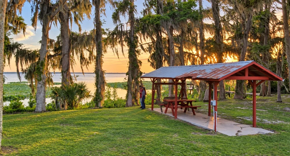 The lakeside picnic shelter and live oaks at sunset